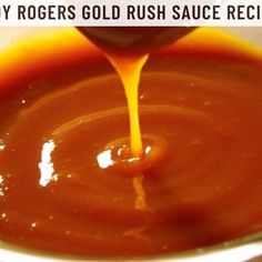 the sauce is being poured into a white bowl with orange liquid in it and text overlay that reads, how do you use baby roger's gold rush sauce recipe?