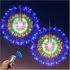 two fireworks are being lit up in the night sky with remote controls to control them