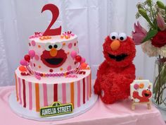 a sesame street birthday cake and elmo the cookie monster