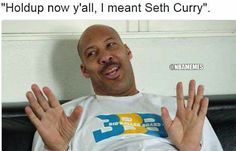 a bald man sitting in a chair with his hands up and saying, holdup now y'all, i meant seh curry