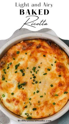 a baked casserole in a white dish with green onions on top and the words light and air baked ricotta above it