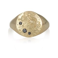 a gold signet ring with black diamonds