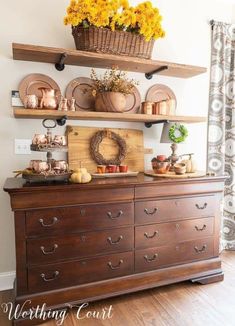 a wooden dresser topped with lots of dishes