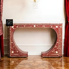 a red and white console table with a black sign on the top that says g