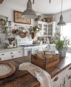 a kitchen with white cabinets and lots of hanging potted plants on the counter top