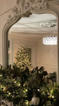 a christmas tree in front of a mirror