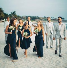 a group of people that are standing in the sand