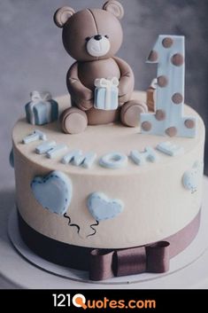 a birthday cake decorated with a teddy bear and the number one for someone's first birthday