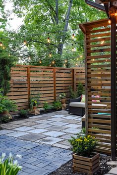 an outdoor patio with wooden fence and seating area