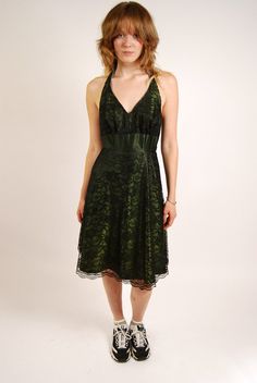 * Size: Small * Vintage y2k fairy halter dress. * Calling all dark fairies! Emerald green mini halter dress with black lace overlay. Unique pattern on halter tie. Solid green waistband and zipper closure on back. Hook and eye on back. * Excellent vintage condition. A few loose threads at bottom front of neckline. No other stains or holes. * Material: Likely polyester and acrylic. Lined. Non-stretch. - MEASUREMENTS - CHEST (doubled) 36" WAIST (doubled) 27" HIPS (doubled) 33" LENGTH (top of should Dark Green Halter Dress, Green Lace Dress For Summer Evening, Summer Evening Green Lace Dress, Green Lace Summer Party Dress, Green Sleeveless Lace Party Dress, Green Vintage Mini Dress For Party, Green Lace Dress For Party, Fitted Green Mini Dress With Lace Trim, Green Fitted Lace Dress