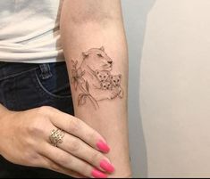 a woman's arm with a tattoo of a dog and flowers on the wrist