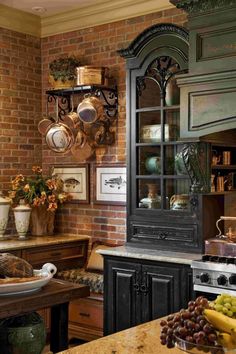 a kitchen with an oven, counter and shelves filled with pots and pans on the wall