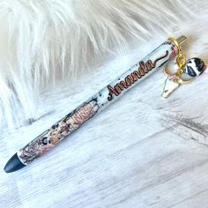 a pen with an animal head and name on it