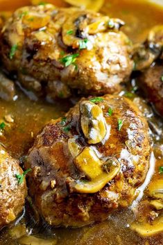 some meatballs and mushrooms are in a sauce