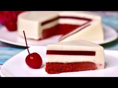 two slices of red velvet cake with white frosting and a cherry on the side