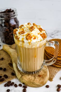 a glass mug filled with coffee and topped with whipped cream