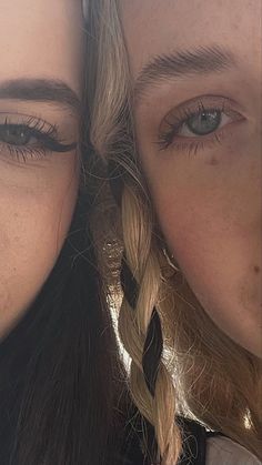 two women with braids are posing for a photo together, one has blue eyes and the other is blonde