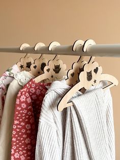 three clothes hangers with hearts and flowers on them