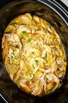 the slow cooker is full of chicken and rice in it's crock pot