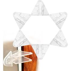 a star shaped object hanging from the side of a wall next to a wooden door