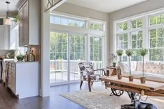 a living room filled with furniture and lots of windows