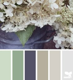 the color scheme is gray, white and grey with some green leaves on top of it