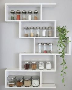 the shelves are filled with spices and jars