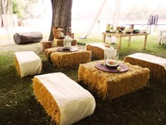 hay bales are set up as tables for an outdoor dinner