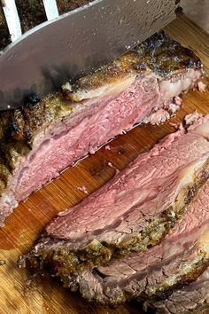 the meat is sliced up and ready to be served on the cutting board with a knife