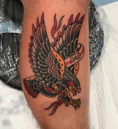 a tattoo on the leg of a man with an eagle in it's talon