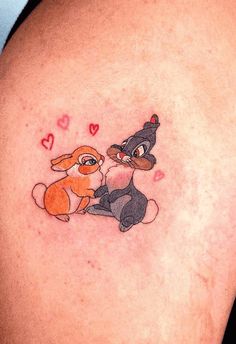 an image of a cartoon tattoo on the back of a woman's shoulder and arm