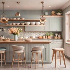 a kitchen filled with lots of counter top space and wooden stools next to it