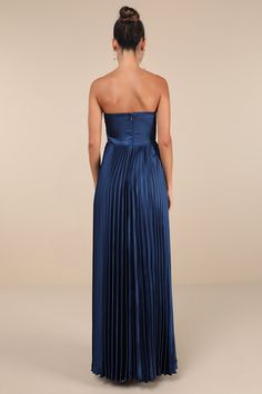 the back of a woman wearing a blue strapless dress