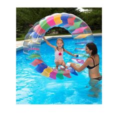 two girls playing in the pool with an inflatable ball and water slider