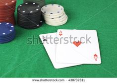 poker chips and playing cards on a green table