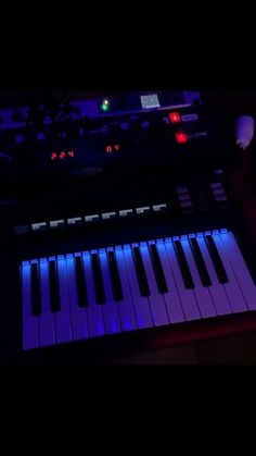 an electronic keyboard lit up with blue lights