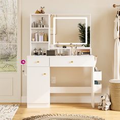 a white dressing table with a mirror and lights on it next to a rug in front of a door