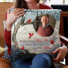 a woman holding a pillow with an image of a man