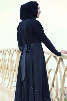 Experience a touch of sophistication with our specially designed abaya featuring a full circle skirt made from premium black Nahda fabric. The abaya boasts a high collar with three hidden clasps and a decorative trim that highlights two elegant shades of black. The included belt allows for adjustable fit, ensuring comfort and style. Please note that the white flowers visible in the images are part of the brand watermark and not the actual design. The trimming and belt design may vary slightly bu Full Circle Skirt, Abaya Dress, Belt Design, Full Circle Skirts, Decorative Trim, Full Circle, Adjustable Belt, Circle Skirt, Shades Of Black