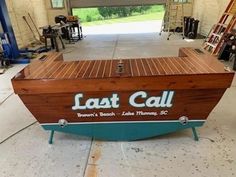 a wooden boat sitting inside of a garage