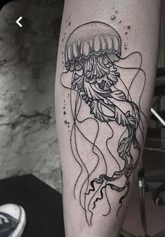 a black and white tattoo of a jellyfish