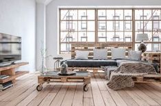 a living room filled with furniture and a flat screen tv on top of a wooden table