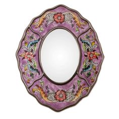 a decorative mirror with flowers and birds painted on it