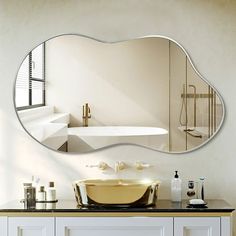 a bathroom with a sink, mirror and bathtub on the wall next to it