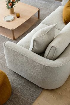 a living room filled with furniture and a coffee table on top of a wooden floor