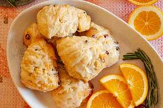 oranges and biscuits on a plate with rosemary garnish