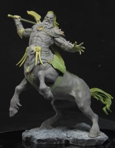 a statue of a man riding on the back of a horse with a spear in his hand