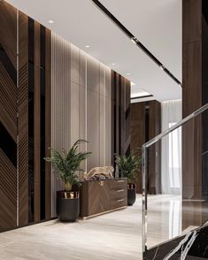 an elegant lobby with marble floors and wooden wall paneling, planters on either side