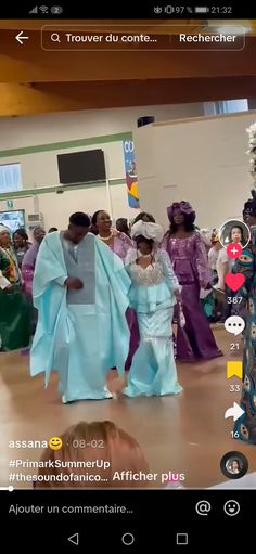 people are dancing on the dance floor in front of a group of women wearing blue dresses