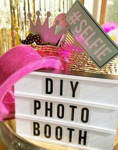 a sign that says diy photo booth with a crown on top and pink ribbon